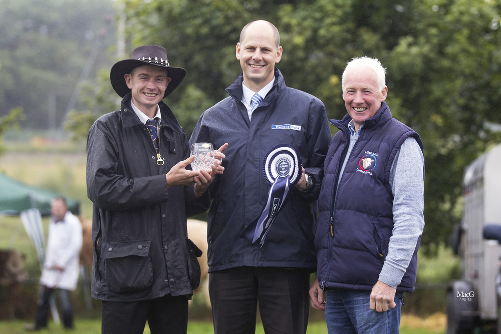 Leslie Weatherup, right, Ballyclare, receives the Danske Bank Reserve Simmental Male of the Year award for his senior bull Dermotstown Delboy, from club chairman Richard Rodgers, and Matthew Johnston, agri-business manager, Danske Bank.    