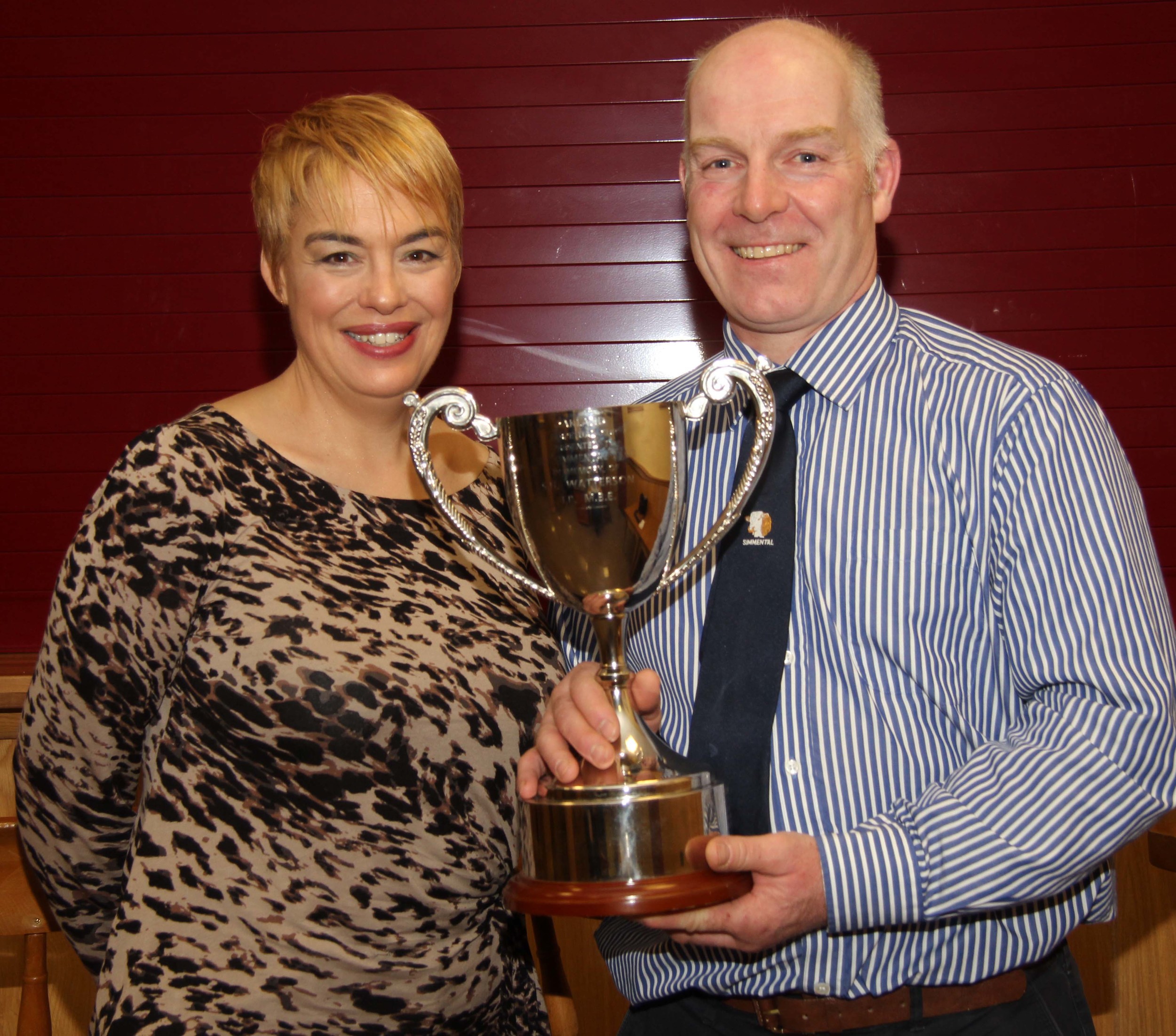 Jill and Norman Robson, Doagh, proudly display the SH Watterson Perpetual Cup for the highest priced bull at the club's spring show and sale. 