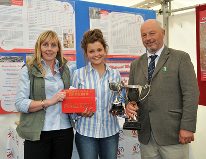 Hannah Wood receives the New Trend Trophy and the Bert Borlase Trophy for Overall Winner, presented by Sponsor Stephanie Denny from the Farmers Guardian and Judge Mr Anthony Davies from the Welston Herd.