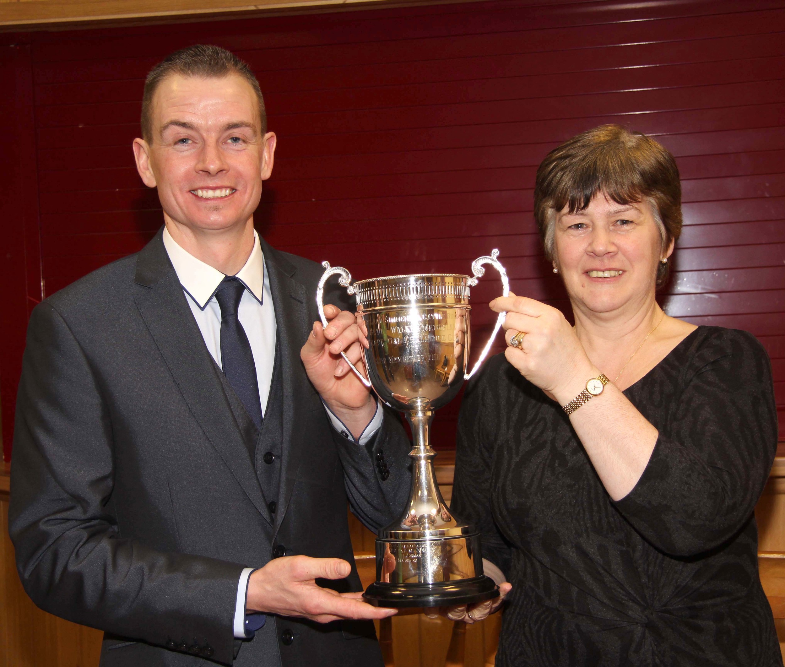 Club Member of the Year Darla Boyd, Portglenone, receives the Betty Walker Memorial Trophy from chairman Richard Rodgers. 