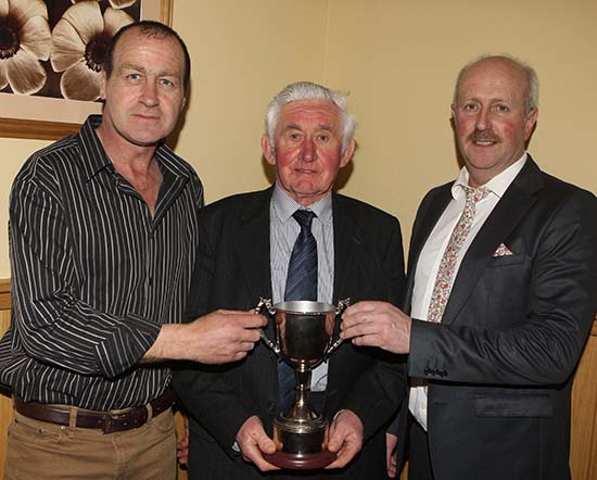 Willie Phair, Lisbellaw, receives the Bruces Hill Trophy for the champion at the autumn show and sale from sponsor Stephen Buick, and club chairman Nigel Glasgow. 