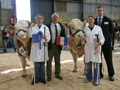 From Left to Right Judge, Mr Ian Malcolm pictured with Champion Bull Lot 50 Halenook Topper, Reserve Champion Lot 52 Corskie Theo and Sponsor from Fraser Tennant